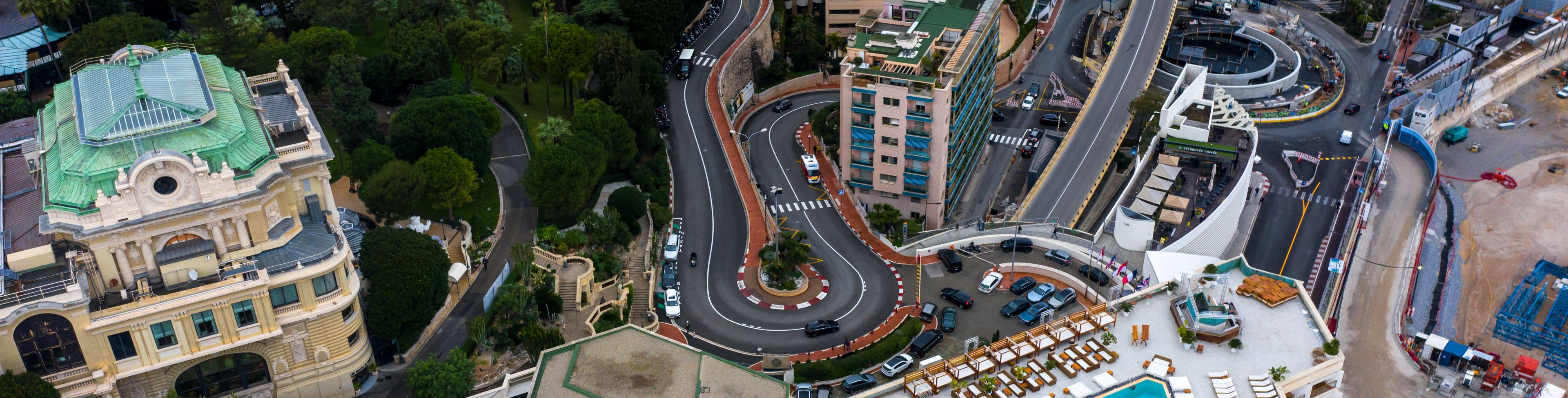 A set of roadways curves between buildings.