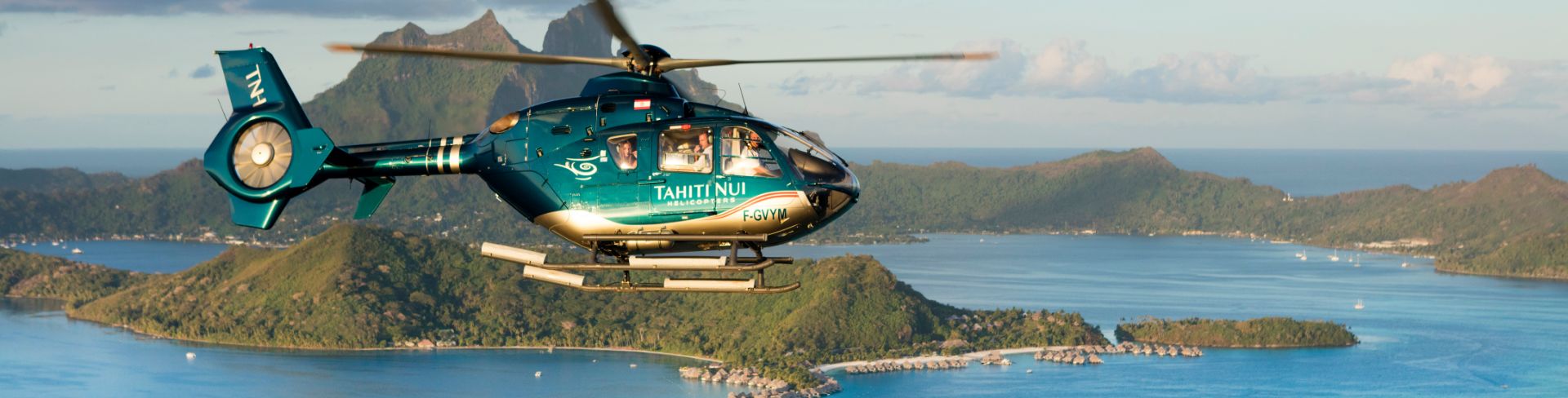 Helicopter flying around an island.
