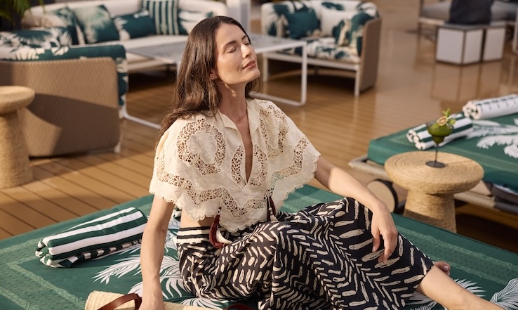 Woman relaxing on a lounger with her eyes closed.