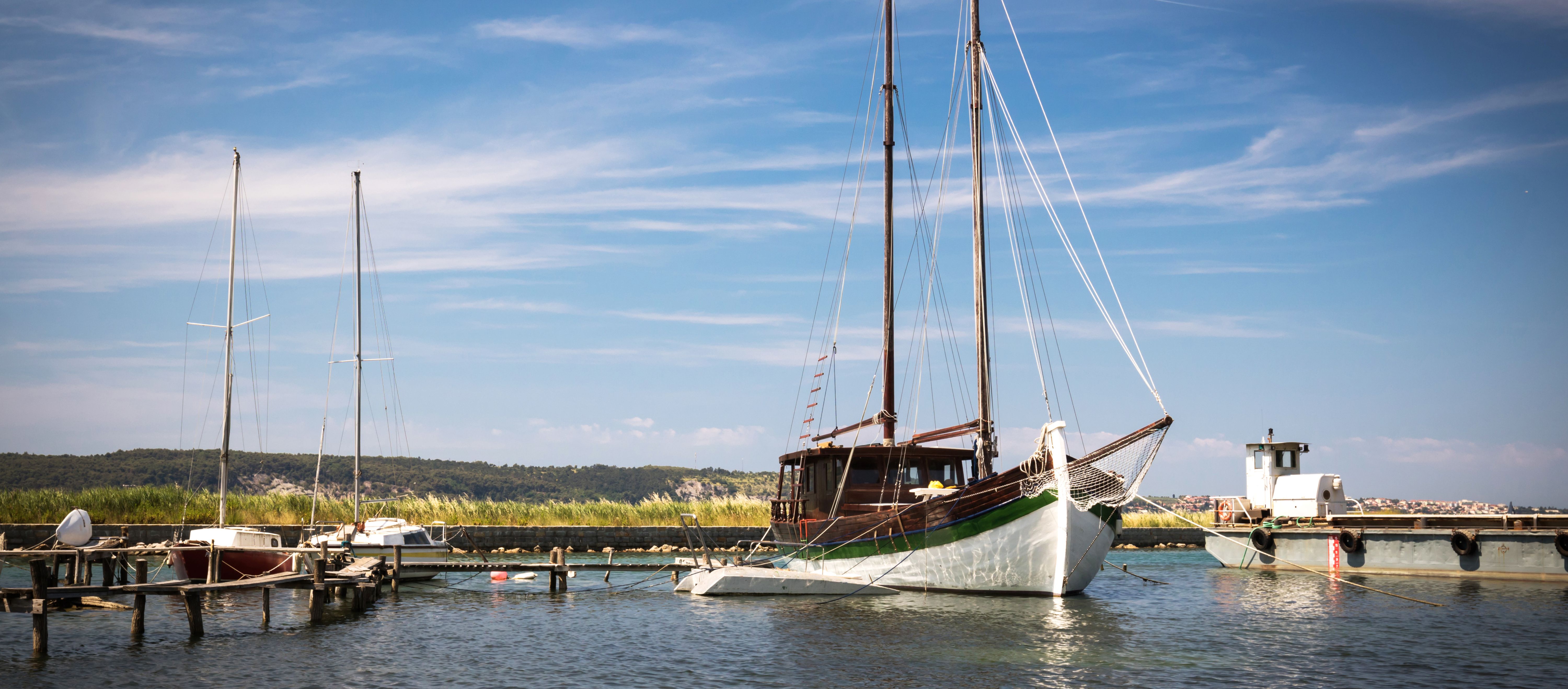 Sailboats anchored at a dock.