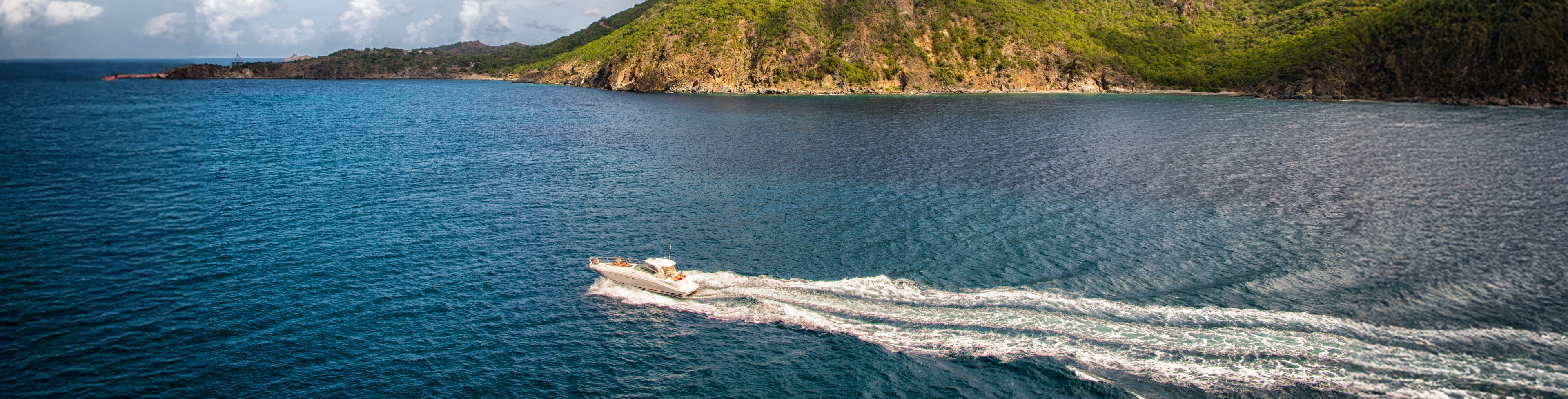Speed boat boating through ocean waters.