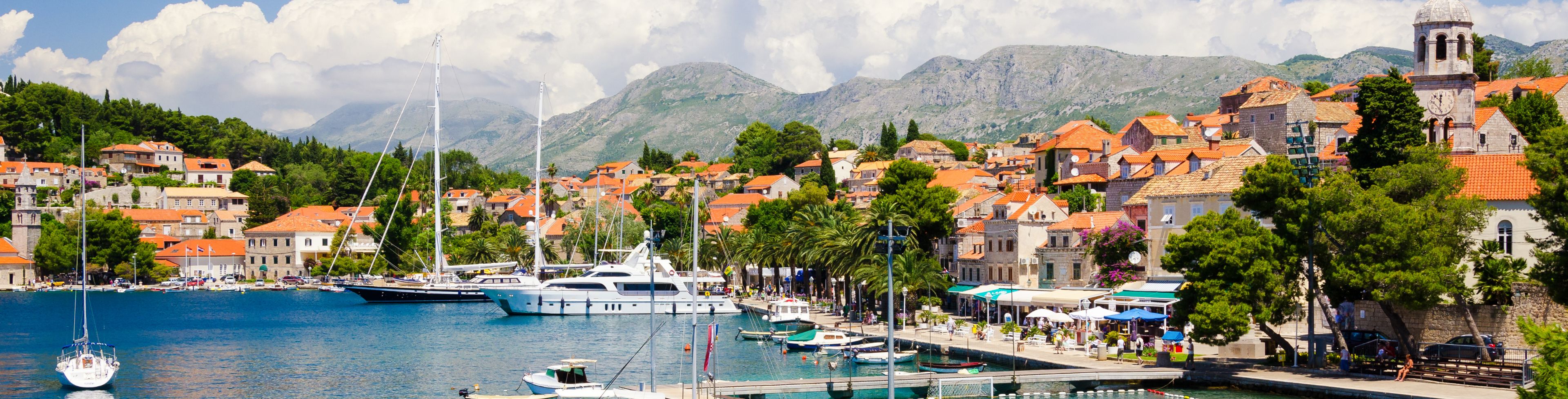 A variety of boats anchored in a marina.