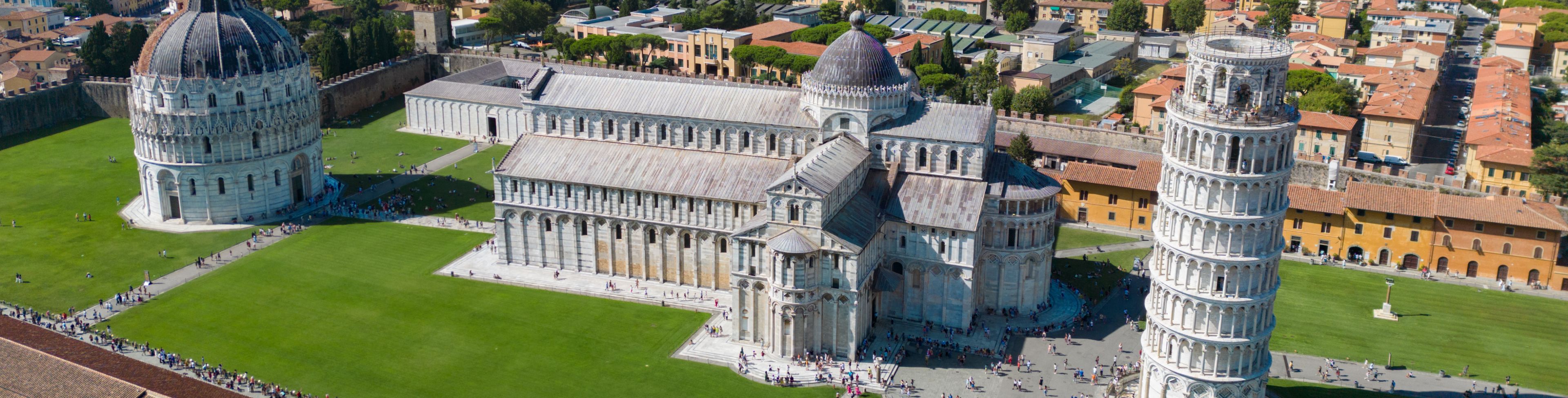 Aerial view of the tower of Pisa and a cathedral. 