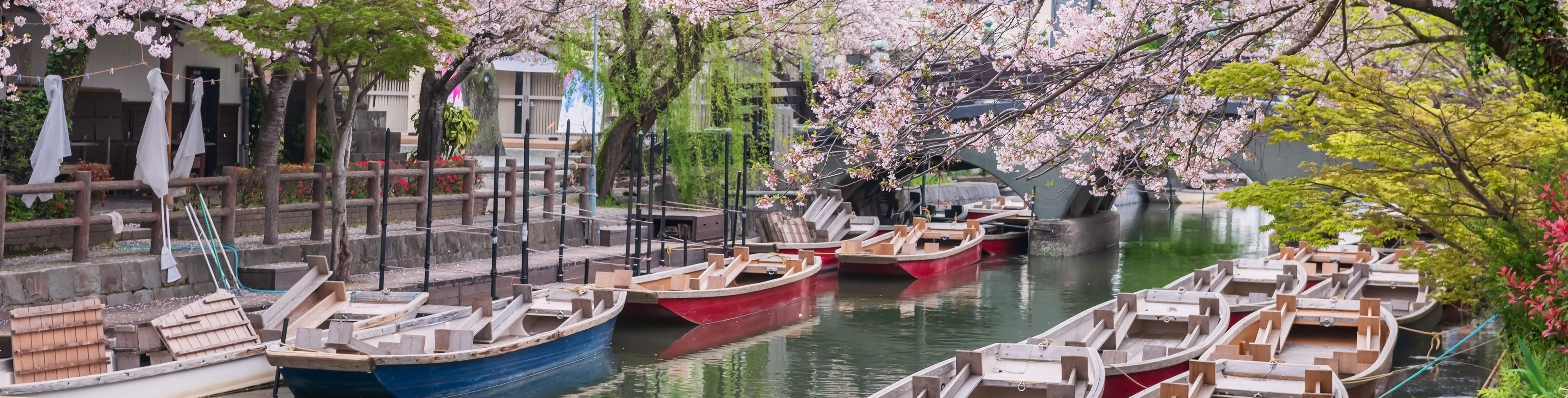 Many boats docked in a canal.