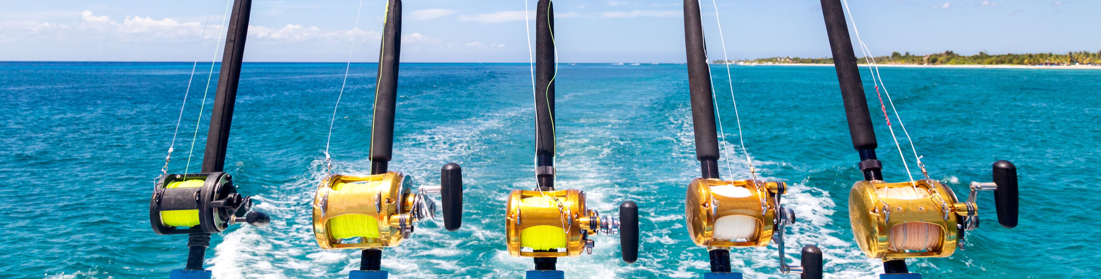 Fishing poles attatched to the back of boat at sea.