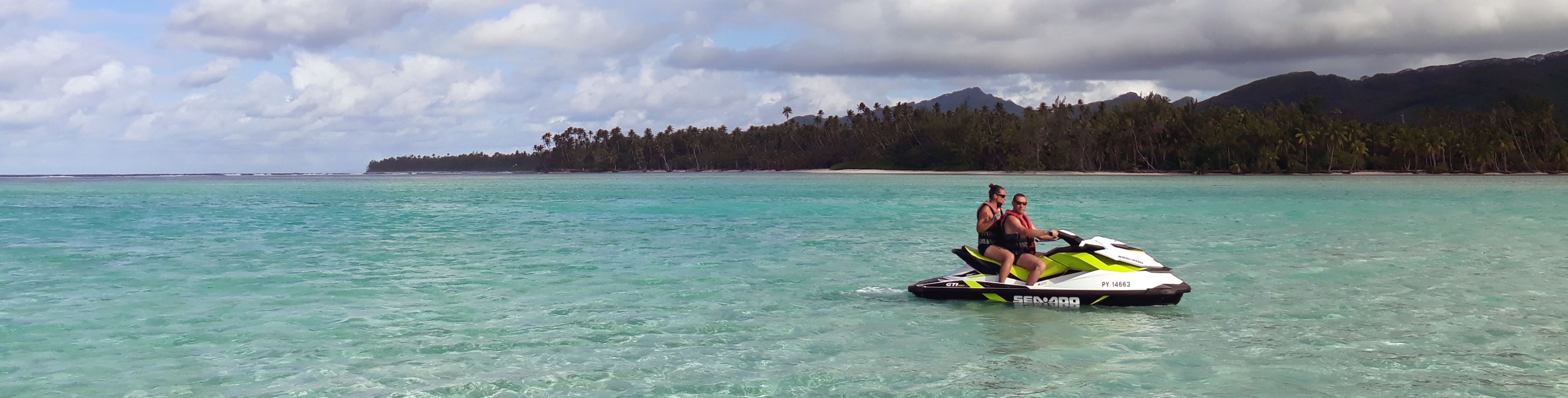 Two people on a jet ski in the ocean.