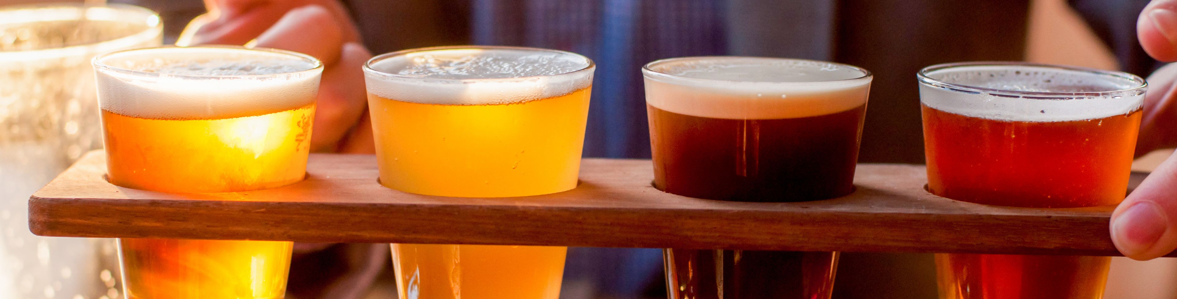 Four beer of a sampler beer tray.